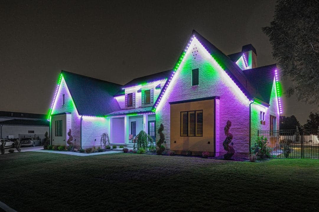 Home illuminated with purple and green permanent Halloween lighting