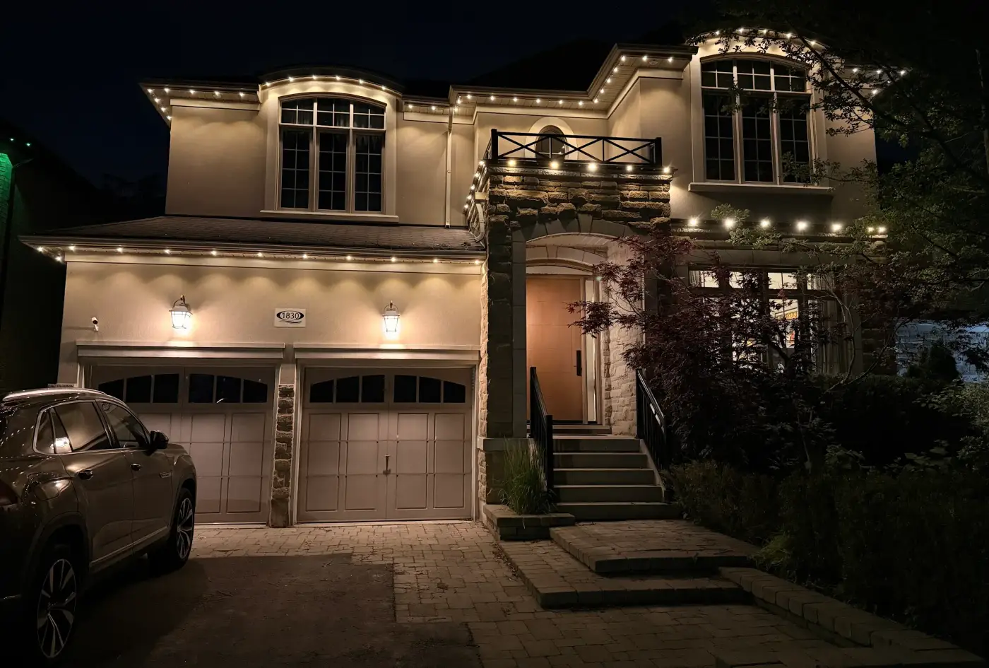 Home illuminated with warm white permanent architectural lighting